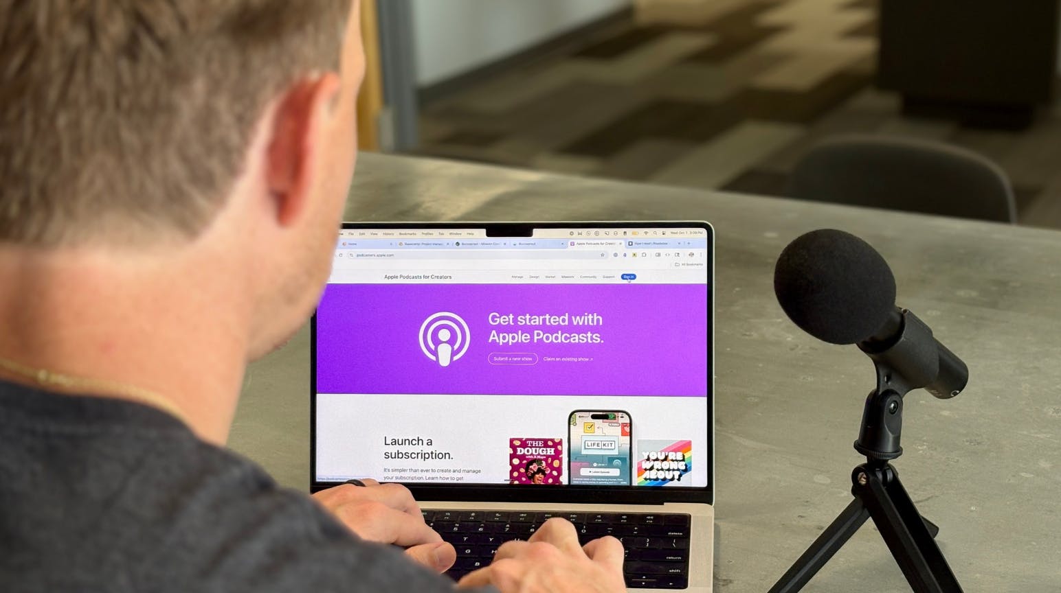 Podcaster looking at Apple Podcasts screen